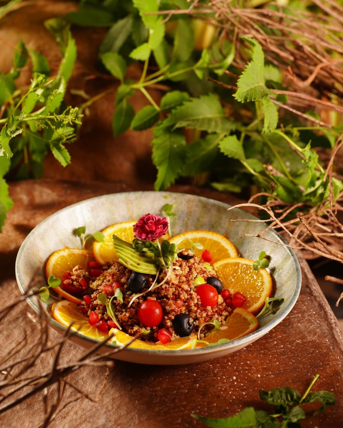 Berry and citrus salad framed by fresh herbs